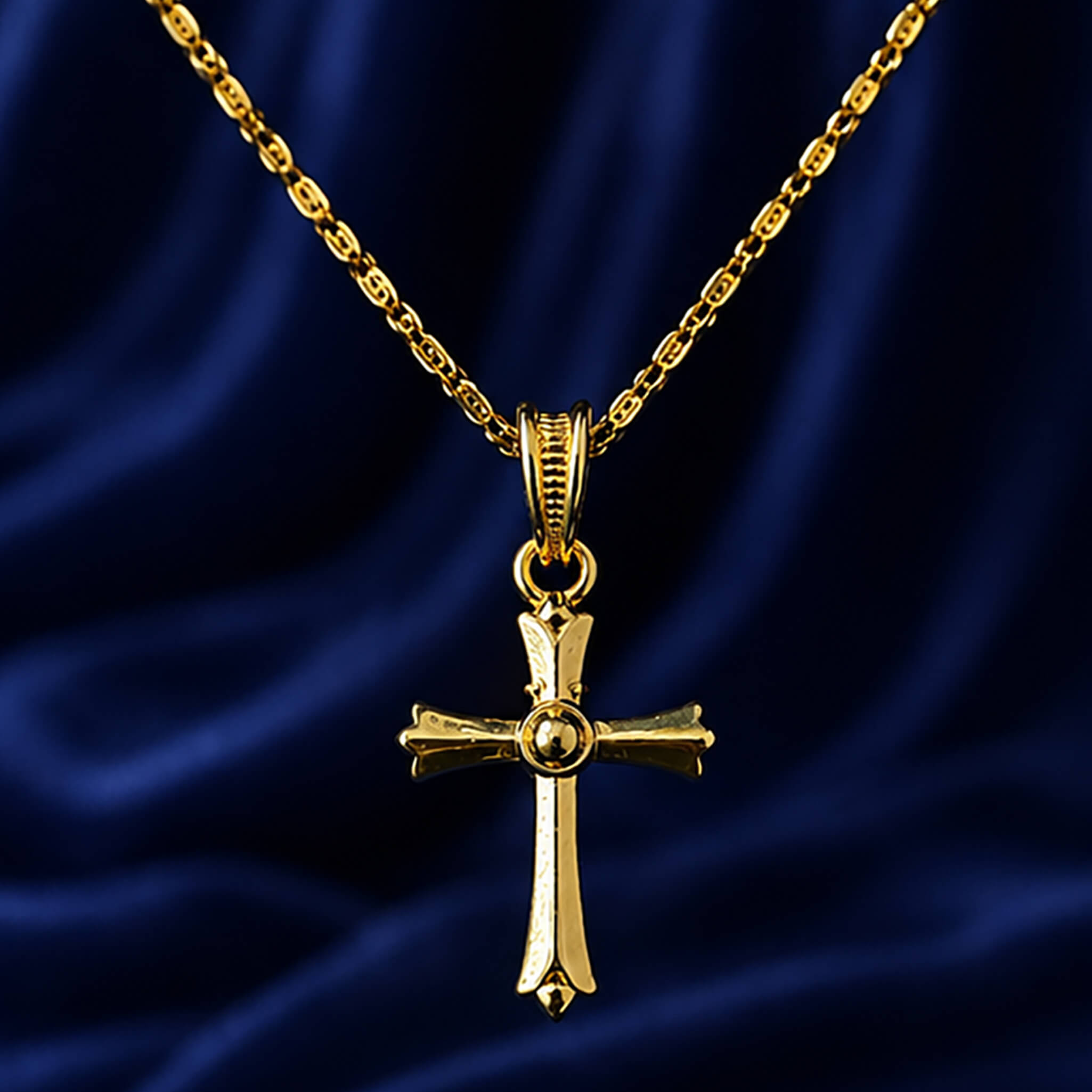 Gold-tone Christian cross pendant displayed on a royal blue velvet background.