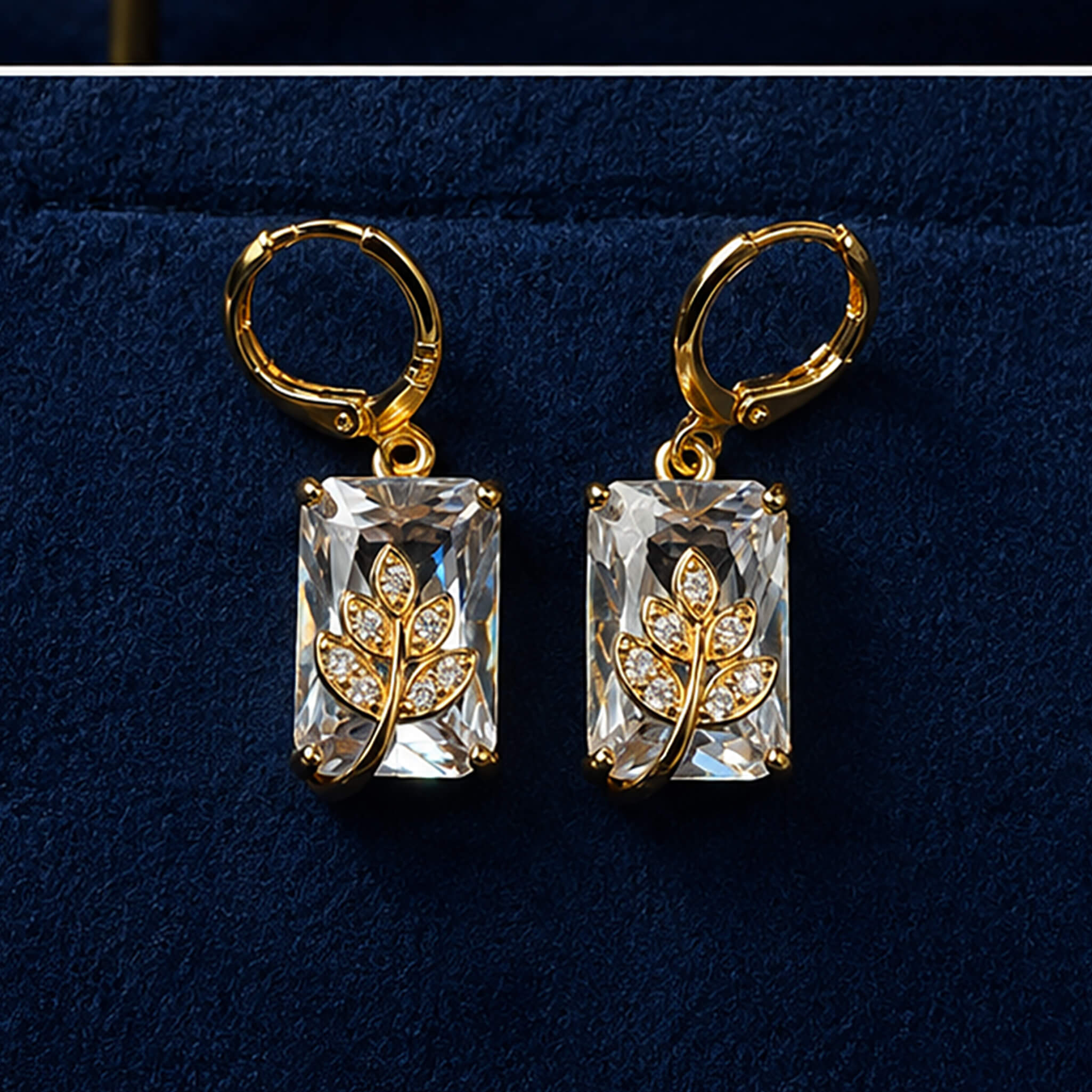 Gold-tone pendant necklace and matching crystal earrings featuring floral motifs displayed on a royal blue velvet jewelry stand.