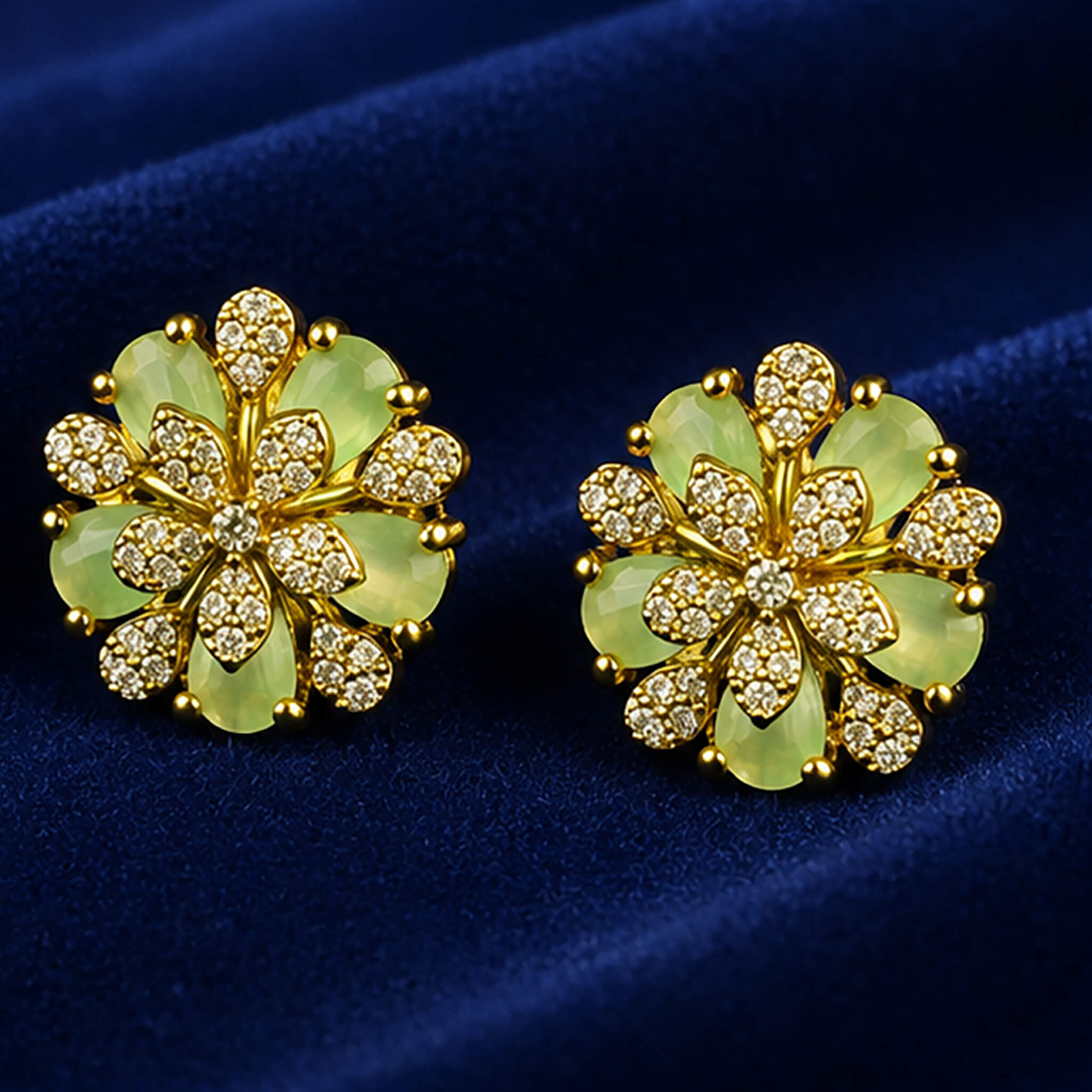 Gold-tone floral necklace set with mint-green petals and matching ear tops displayed on a royal blue velvet jewelry stand.