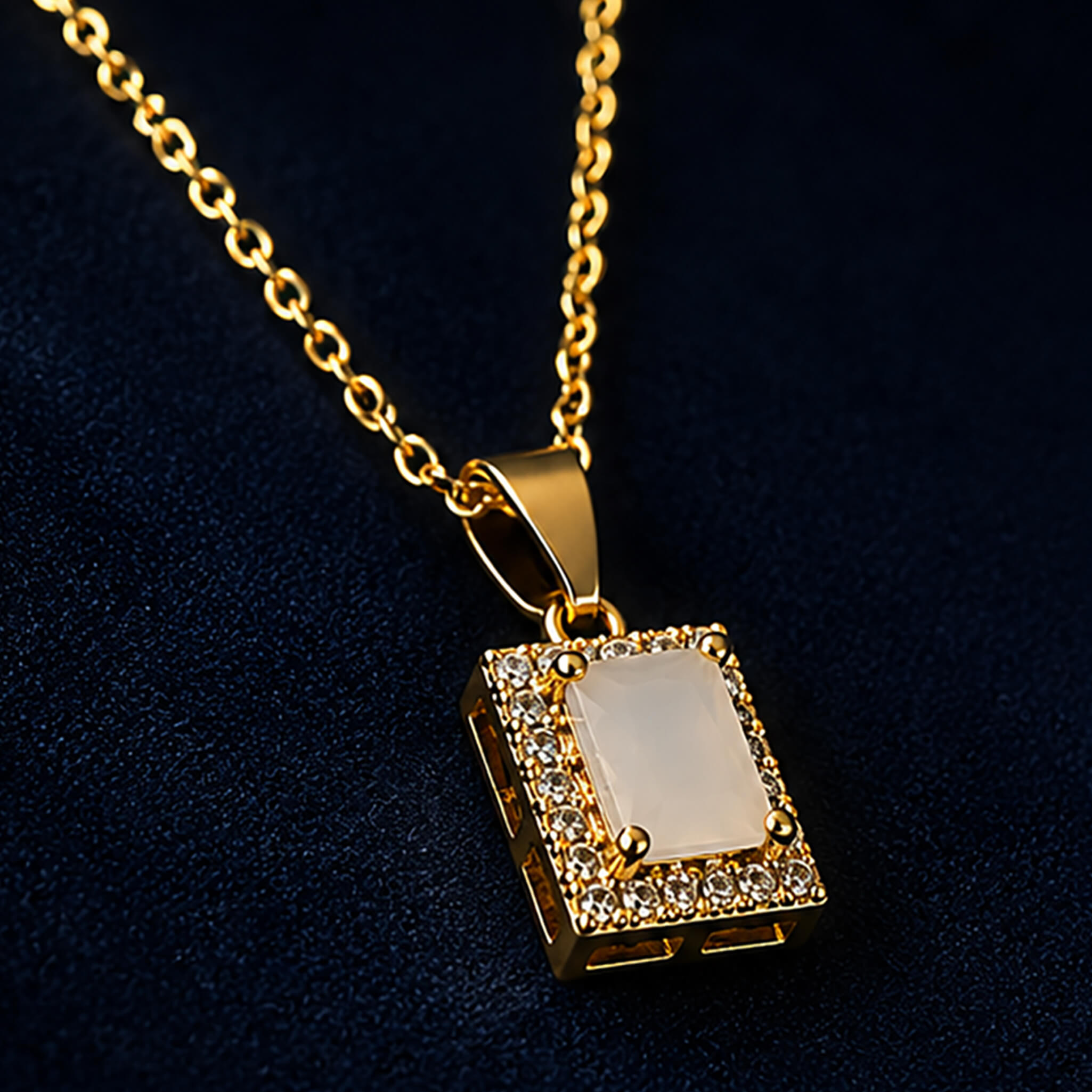 Gold-tone pendant necklace and matching earrings with ivory-white rectangular stones and crystal accents on a dark blue background.