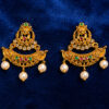 Traditional gold-tone chandbali ear tops with ruby and emerald stones, crystal accents, and pearl drop embellishments on a royal blue background.